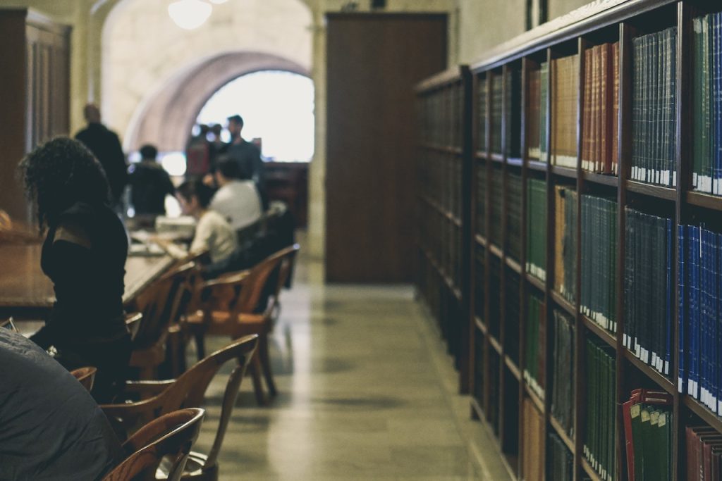 Shelves of books and tables in a library